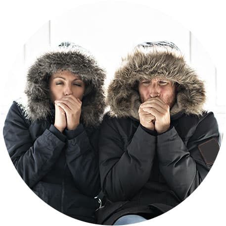 a man and woman shivering in heavy coats